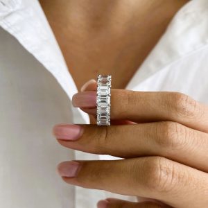 Emerald cut diamond eternity band with shared prong and open gallery design