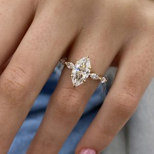 Marquise engagement ring with alternating marquise and round side stones along the band