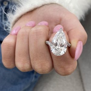 Pear cut engagement ring with split shank and pavé diamonds in a five prong setting