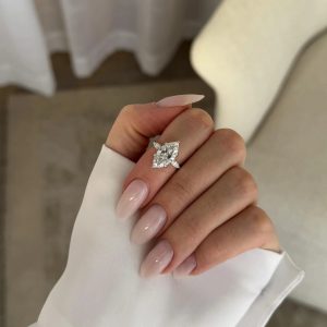 Marquise three-stone engagement ring with pear-shaped side diamonds on a plain shank
