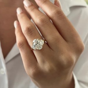 Elegant oval three stone engagement ring with a plain polished band