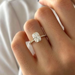 Elongated cushion engagement ring with pavé band in four-prong setting