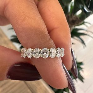 Shared prong eternity band with uniform round stones encircling the ring