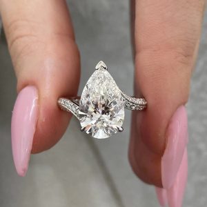 Pear-shaped split shank engagement ring with pavé accent diamonds