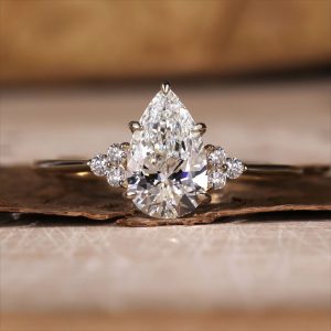 Oval three stone engagement ring with polished band and open gallery