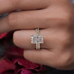 Radiant cut pavé solitaire engagement ring with baguette diamond band