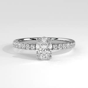Oval center pavé engagement ring with cathedral shoulders, shown in two-tone metals