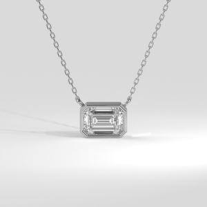 Emerald cut diamond bezel pendant suspended horizontally from a delicate chain